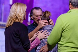 Get to Know Bishop Brett.  In this photo Bishop Brett is prayer during a service.